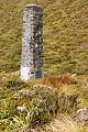 The pillar marking the pass. Note the scrubby vegetation - high rainfall but alpine and windy.