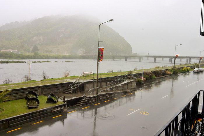 Greymouth... rain... what more can I say? View from the window of the backpackers, looking upriver towards my old camping spot on the far side of that bridge (now a construction depot).