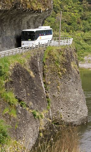 Tour bus going through the cut at Hawks Crag (Buller Gorge). Slowly, partly because big trucks use this road too.