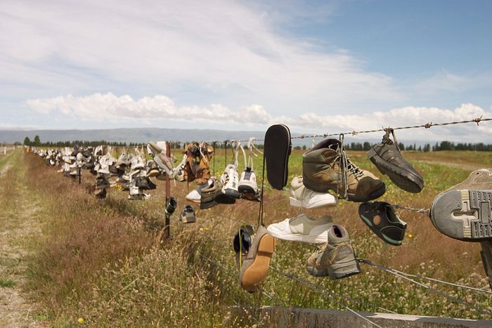 A fence covered in shoes. No idea why but there are several of these in Anglonesia.